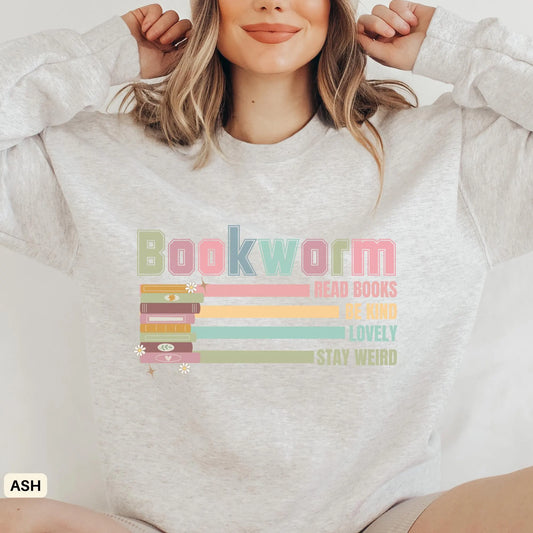 A woman wearing a gray sweatshirt with the word 'Bookworm' and various book-related phrases embroidered on the front.