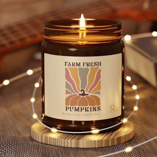 A scented candle with 'Farm Fresh Pumpkins' label is the perfect cozy gift for fall season