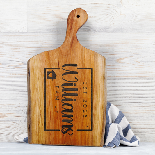 Wooden cutting board with engraved text on a light wooden background