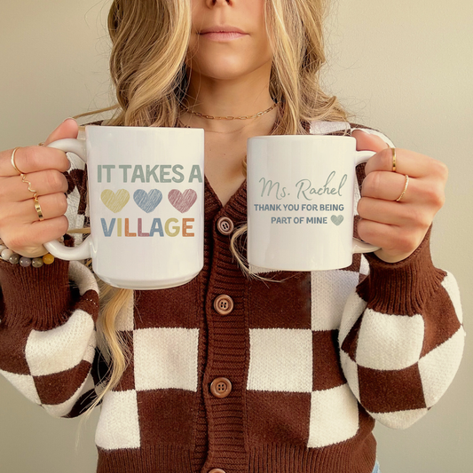 ceramic mug with the phrase it takes a village and thank you for being part of mine that can be personalized with a name  and it's the perfect gift for daycare and teachers and mentors helpers